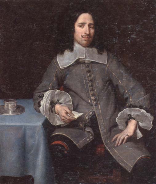 Portrait of a gentleman,three-quarter length,standing beside a table